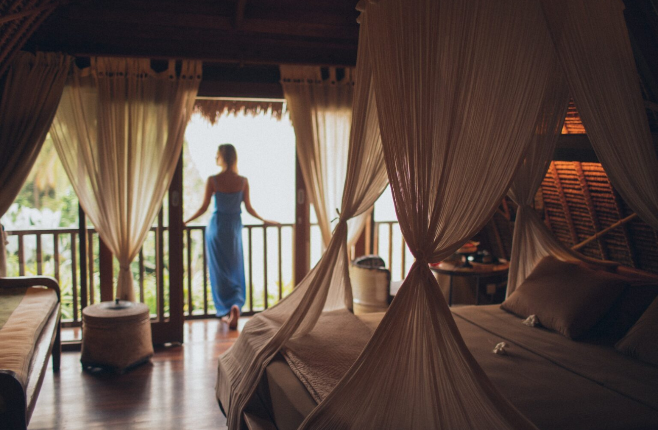 woman looking out of window at women's retreat - best women-only hotels in the world 2023