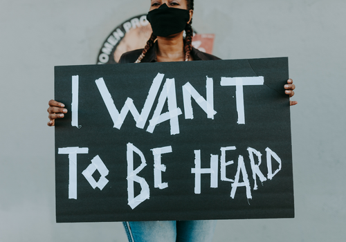 Woman-Holding-Sign-Feminism-Activism-Women-Issues