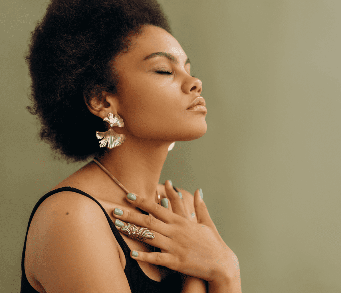 Spiritual Black Woman Closing Eyes Holding Crystals to Chest