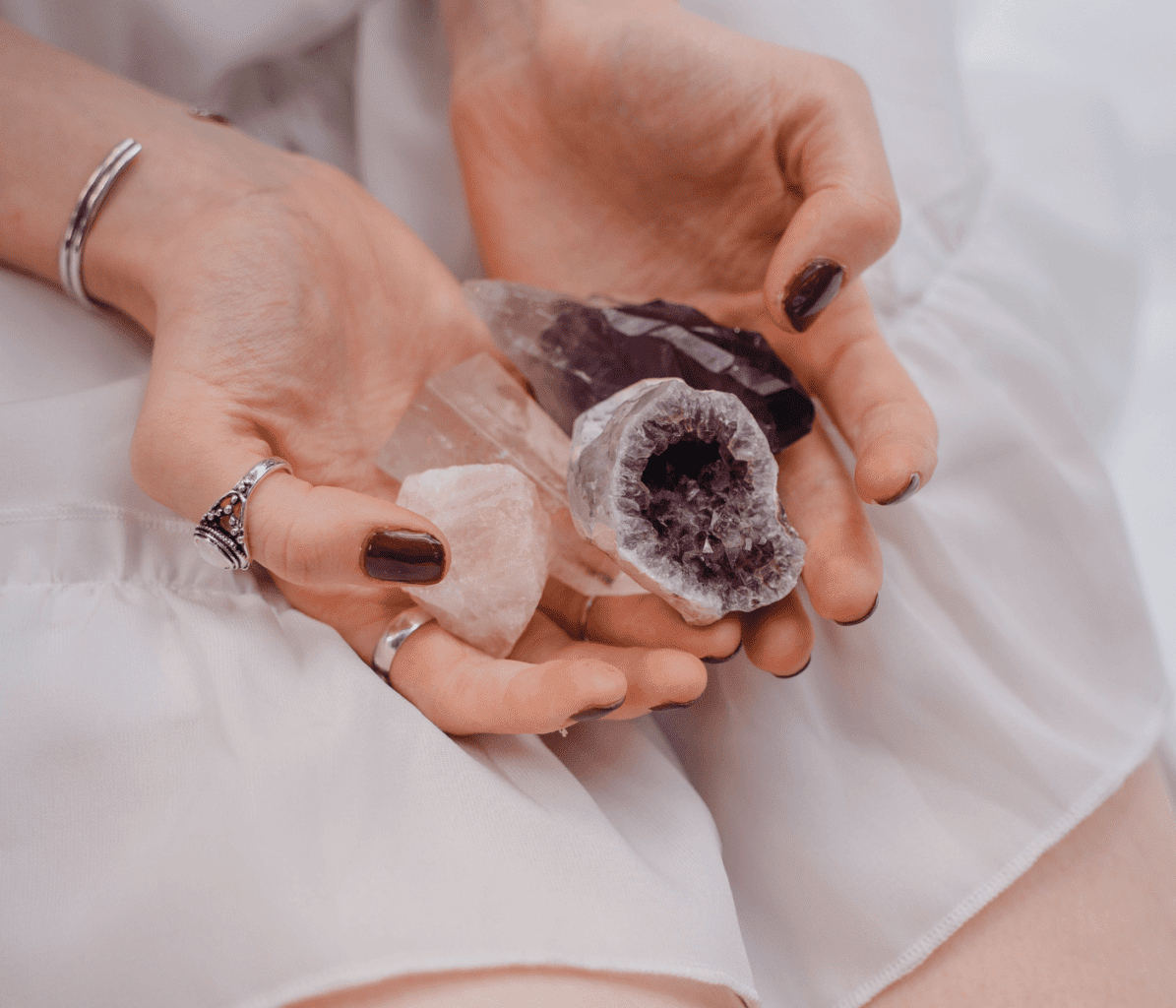 Spiritual Woman's Hands Holding Different Crystals