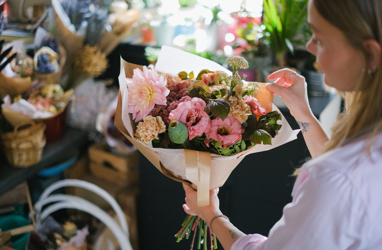 Woman Choosing Bouquet of Flowers at Local Florist - Best Flower Delivery Services UK