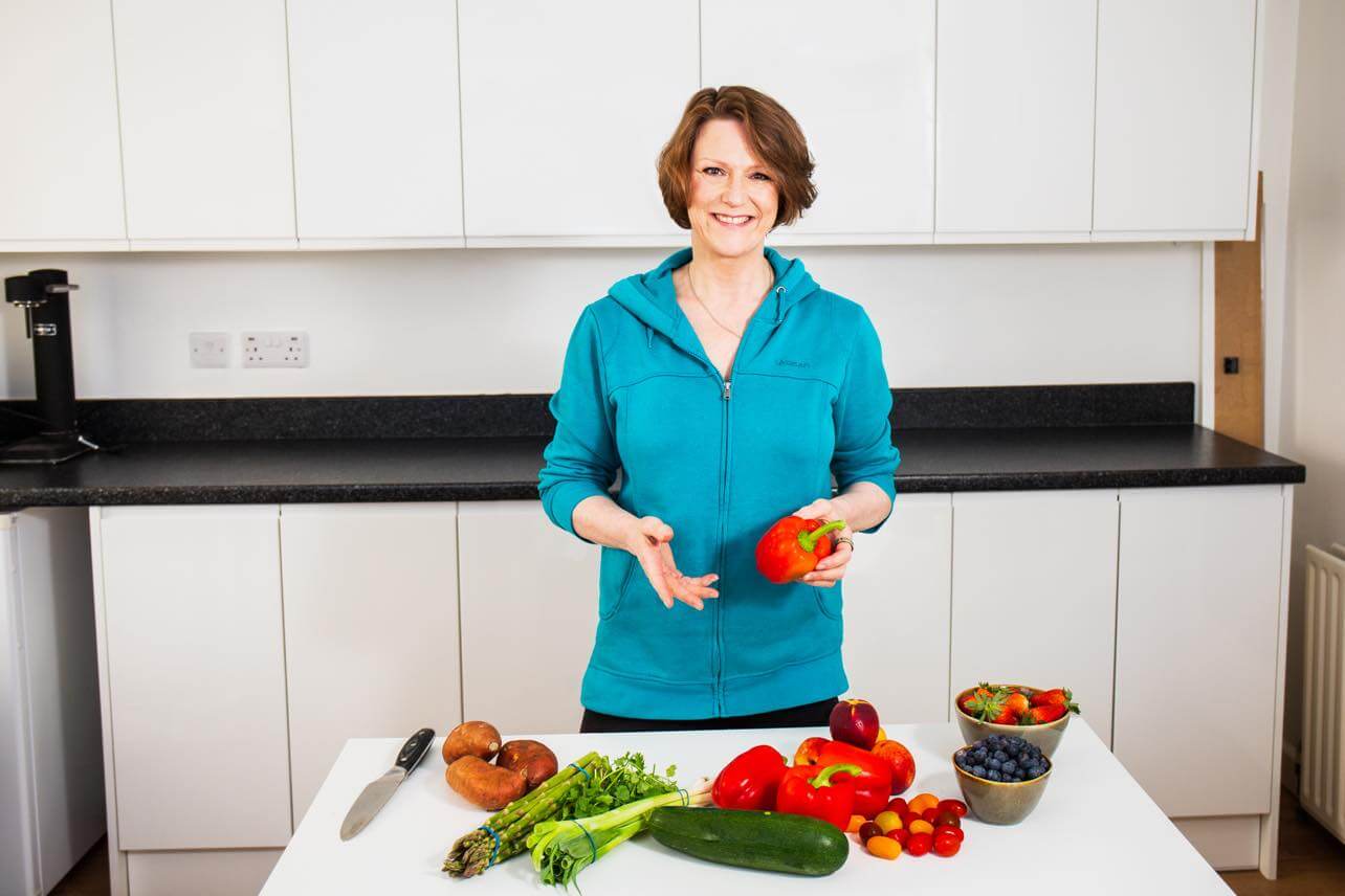 Women of a Certain Stage Founder Lauren Chiren in Kitchen With Fruit and Vegetables - Plant-Based Diet: Health Benefits For Women
