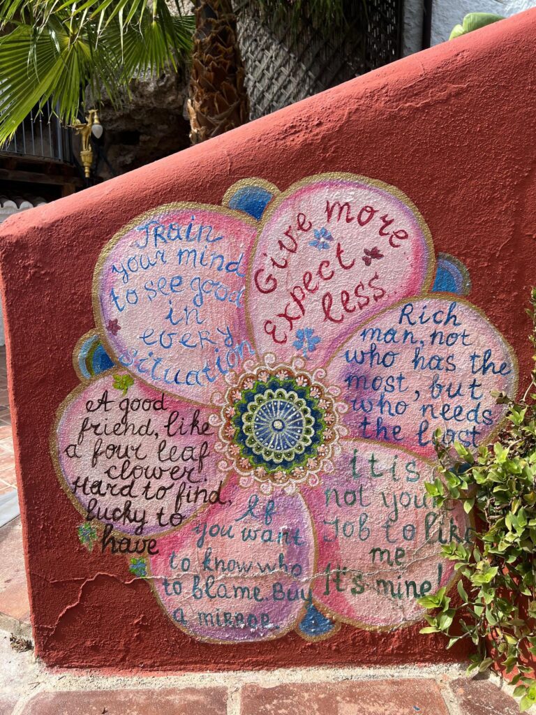 Hand-painted mural with inspiring quotes and mandala art at Molino del Rey retreat in Spain