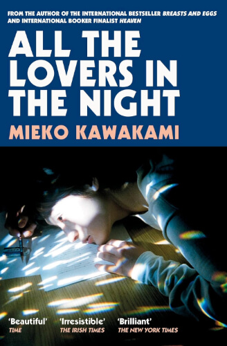 Cover of All the Lovers in the Night by Mieko Kawakami, showing a softly lit photograph of a woman resting her head on a desk beneath bold blue title text. The subdued, intimate image mirrors the novel’s quiet exploration of loneliness and connection in Tokyo.