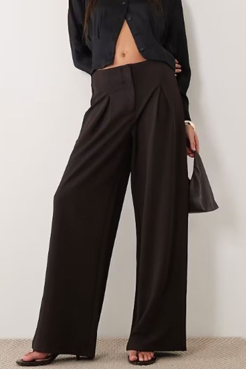 Model wearing ASOS DESIGN slinky twill tailored slouchy wide leg trouser in chocolate, relaxed work trousers for women