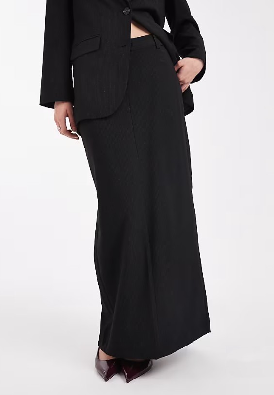 View of a model wearing ASOS Vero Moda tailored maxi skirt co-ord in black and white pinstripe, a women's workwear co-ord