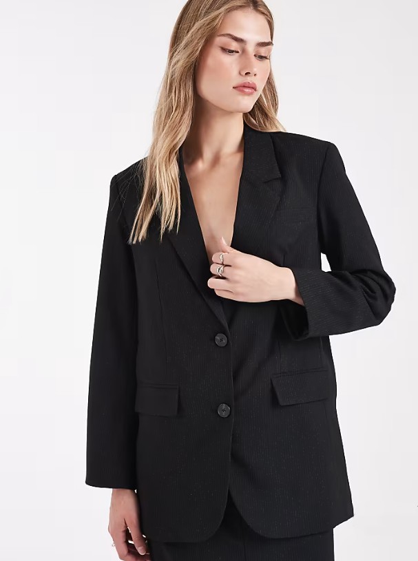 Model wearing ASOS Vero Moda tailored oversized blazer co-ord in black and white pinstripe, a women's workwear co-ord