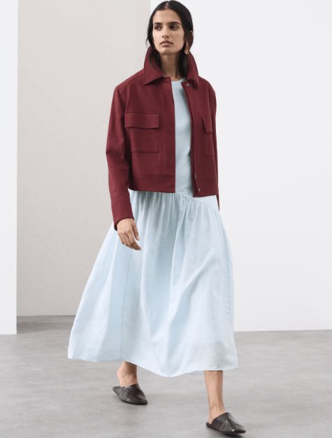 Model wearing M&S Autograph Linen Rich Asymmetric Midaxi Dress in dusty blue, a light blue sleeveless dress with an asymmetrical gathered waist