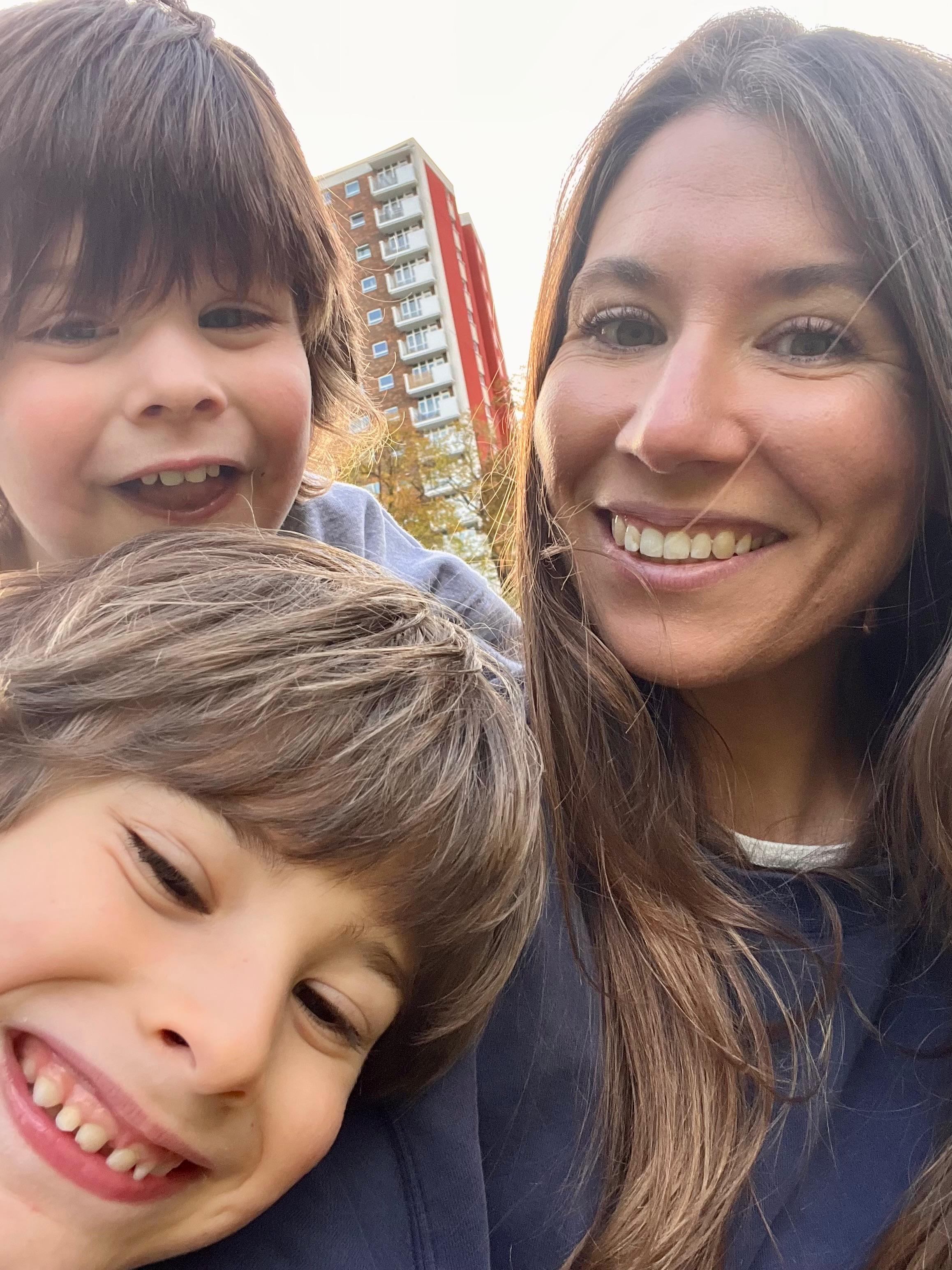 Danielle Wilkins, The Women’s Journal journalist and mum of boys taking a selfie outdoors with her two young sons