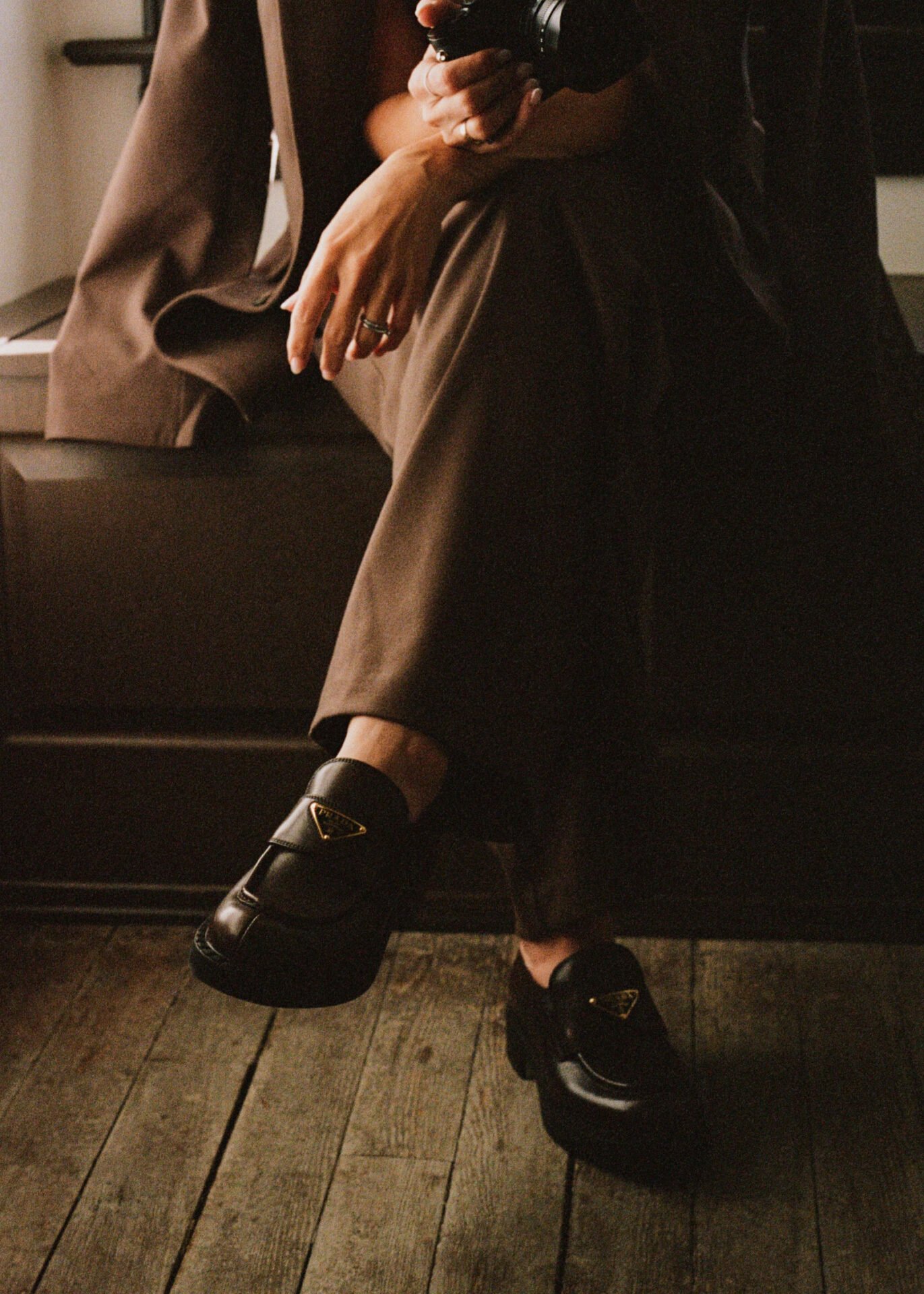 Woman in professional workwear sitting with a camera, illustrating women's rights at work in the UK 2026