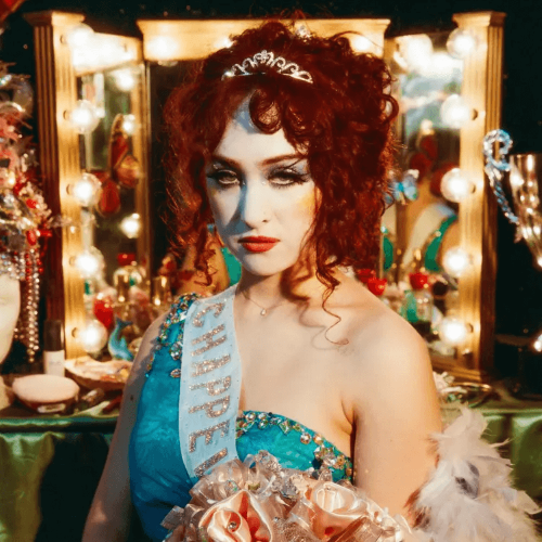 Chappell Roan wearing a tiara and turquoise pageant dress in a dressing room from The Rise and Fall of a Midwest Princess album artwork