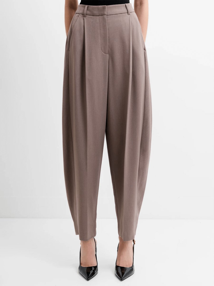 French Connection Vienna Tapered Trousers in taupe brown with pleated front and high-waisted tailored fit. Smart tapered work trousers styled with black heels for a modern office outfit