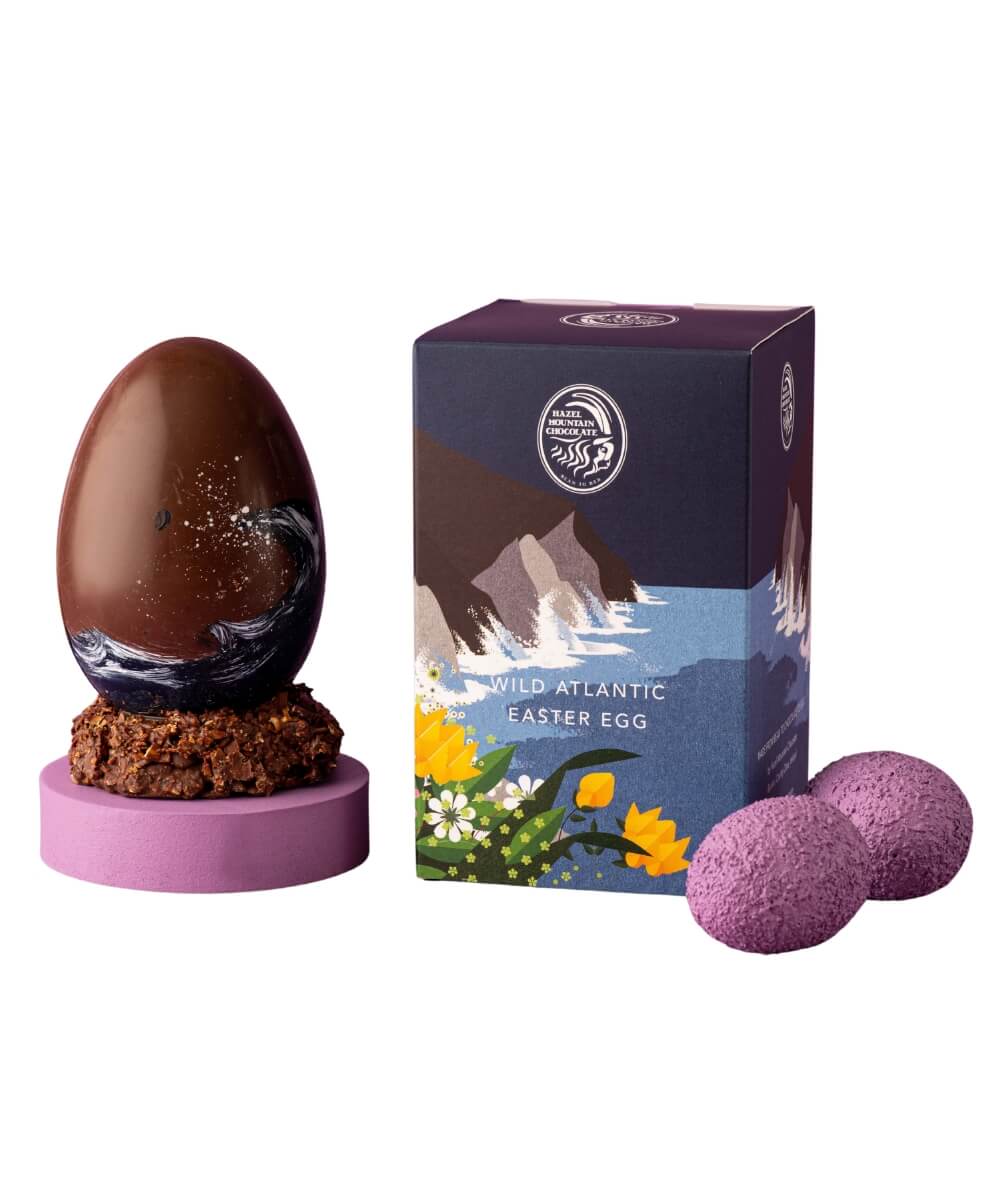Hazel Mountain Chocolate Wild Atlantic Easter egg with hand-painted chocolate shell beside illustrated Wild Atlantic Way gift box 