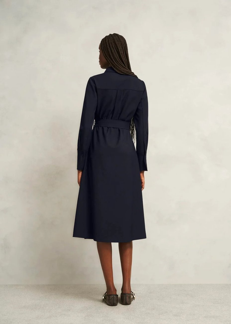 Back view of a model wearing Hobbs Lyla Dress in navy, a long-sleeve, tailored dress with a belt