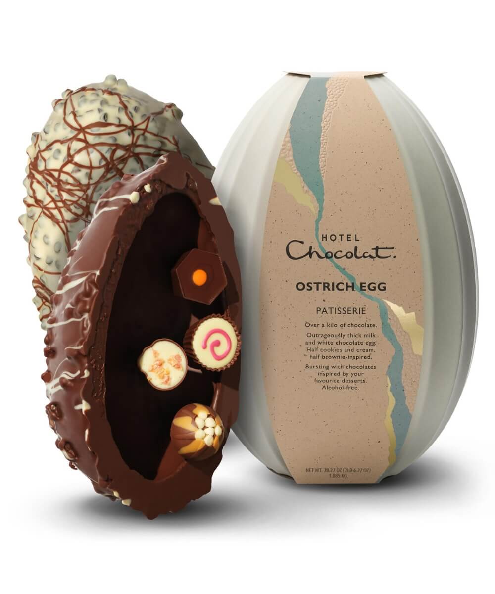 Hotel Chocolat 1kg Patisserie Ostrich Easter egg luxury chocolate egg filled with assorted patisserie-inspired chocolates including brownie and cookies and cream, shown with decorative ostrich egg packaging