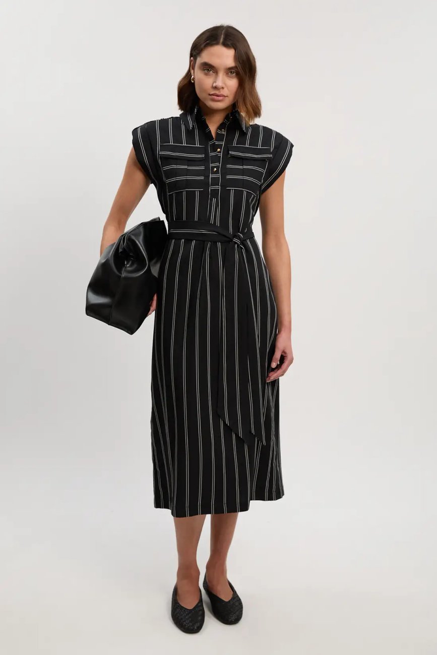 Model wearing Karen Millen bold stripe cotton woven maxi shirt dress in black with white stripes, styled with a waist tie and black flats
