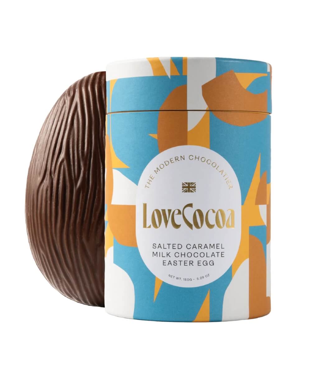 Love Cocoa salted caramel milk chocolate Easter egg in a blue, white and orange patterned tin with a half milk chocolate egg beside it