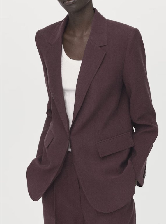 Model wearing the Mango Lyocell suit in purple, featuring a tailored blazer with two front pockets