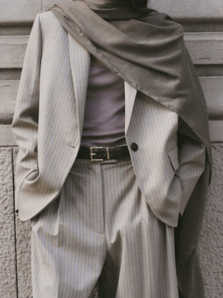 Mango Wool-blend suit blazer in medium brown, styled with matching wide-leg pinstripe trousers, a belt, and a draped scarf