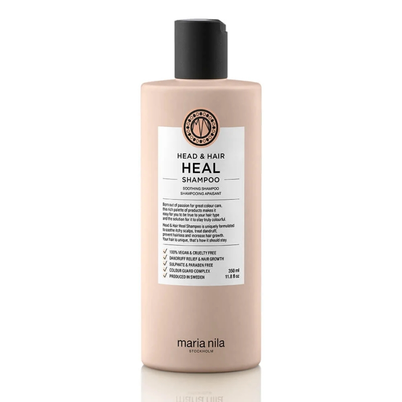 A bottle of Maria Nila Head & Hair Heal Shampoo, featuring a pink label and a black pump top