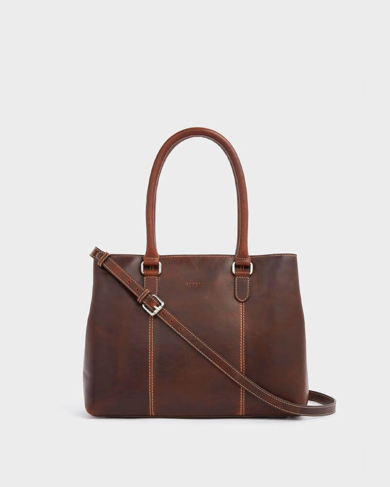 Chestnut brown Osprey London The Madden leather shoulder bag with structured silhouette, twin top handles and detachable crossbody strap. The smooth leather finish and contrast stitching create a polished, everyday work bag look.