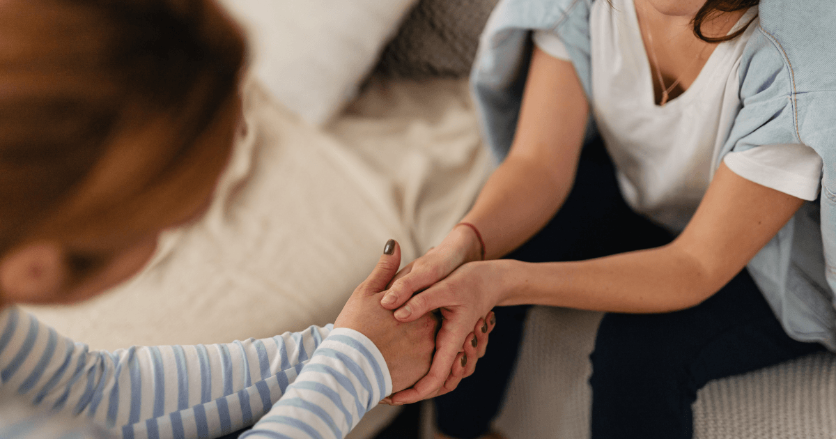 Supportive conversation between two women discussing perimenopause symptoms and emotional wellbeing.