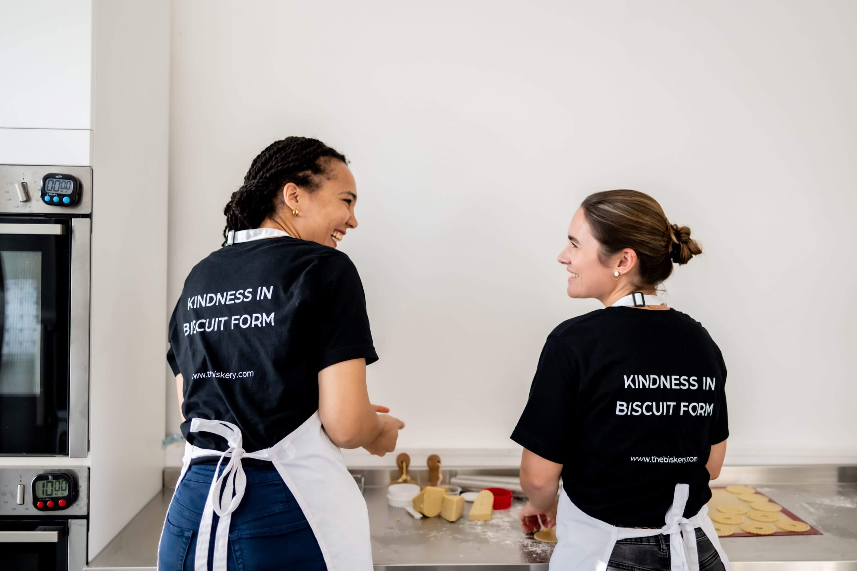 Lisa de Boer and Saskia Roskam preparing biscuits together at The Biskery bakery in Leeds, showcasing the women-led gifting business built around flexible working and motherhood