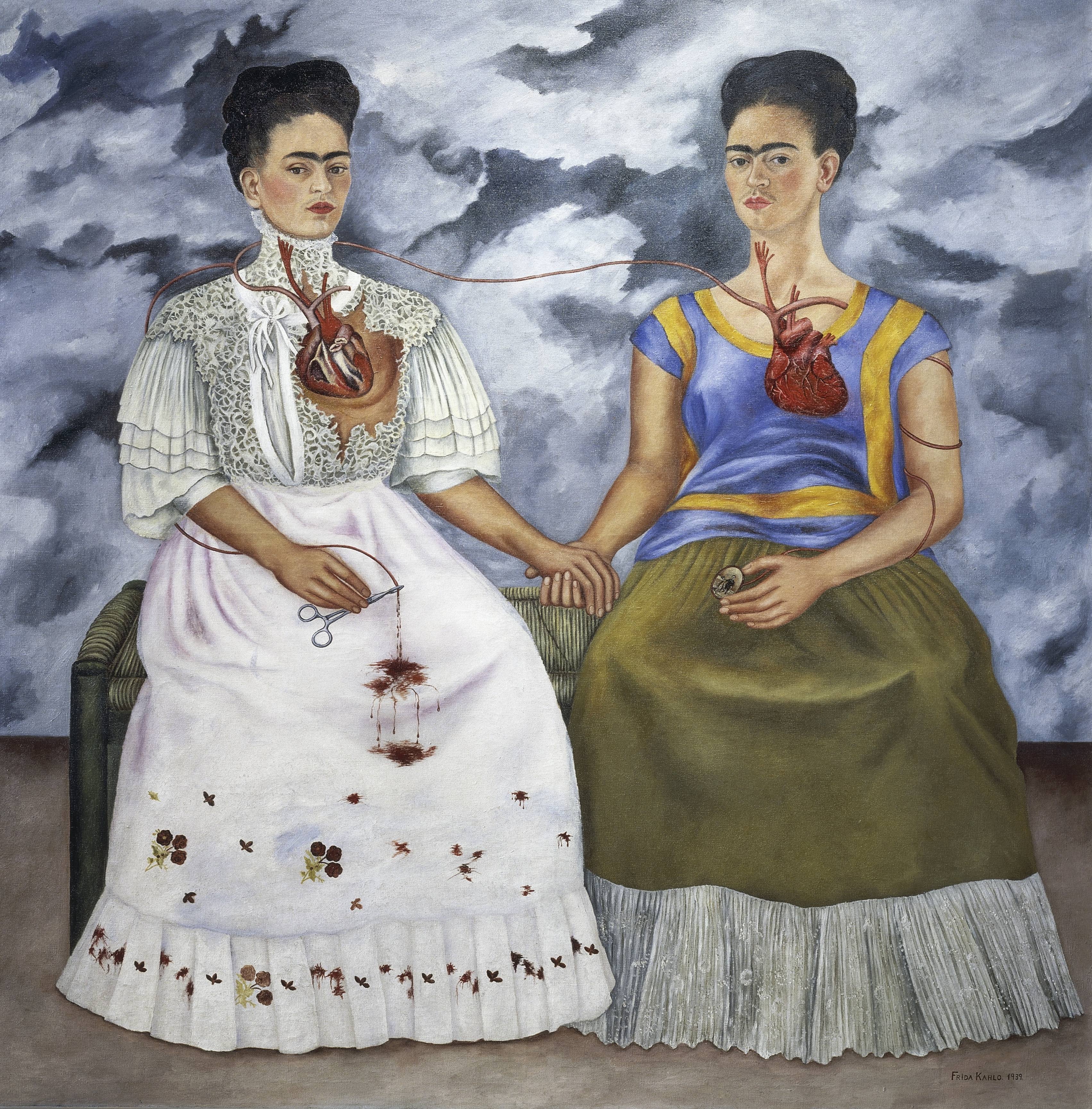 A surrealist double self-portrait by Frida Kahlo showing two versions of herself seated on a bench, holding hands and connected by a shared vein between their exposed hearts.